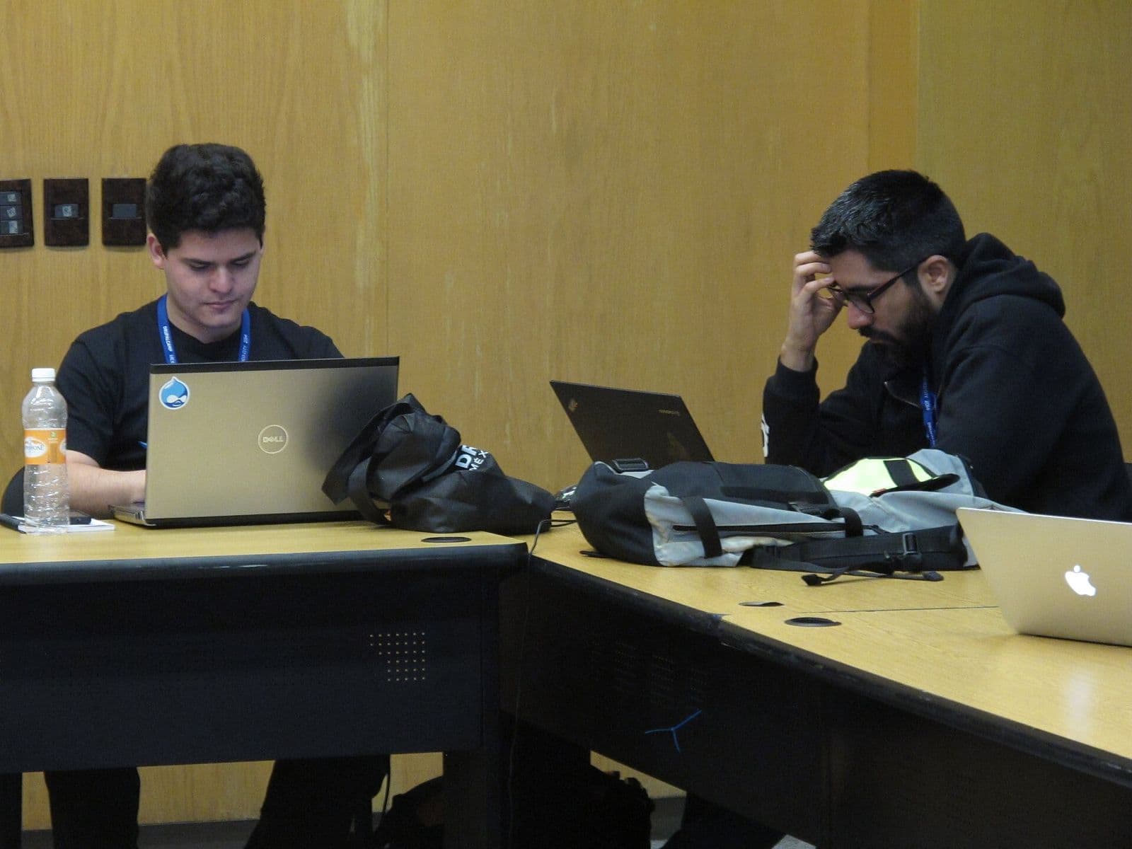 Two developers working side by side at DrupalCamp Mexico